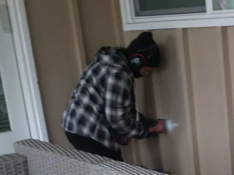 Professional electrician installing an exterior outlet in Barre